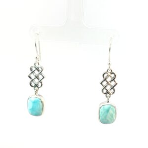 These serene Celtic Knot Larimar Drop Earrings feature genuine natural Larimar, prized for its tranquil sea-blue and turquoise hues found only in the Dominican Republic. Set in polished sterling silver, each Larimar gemstone displays unique marbling reminiscent of ocean waves — no two stones are alike.